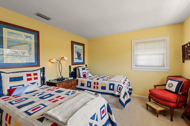 carpeted bedroom featuring visible vents and baseboards