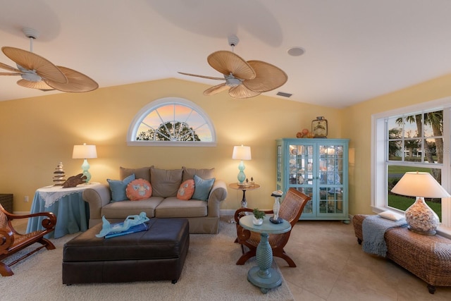 tiled living area with visible vents, lofted ceiling, and a ceiling fan