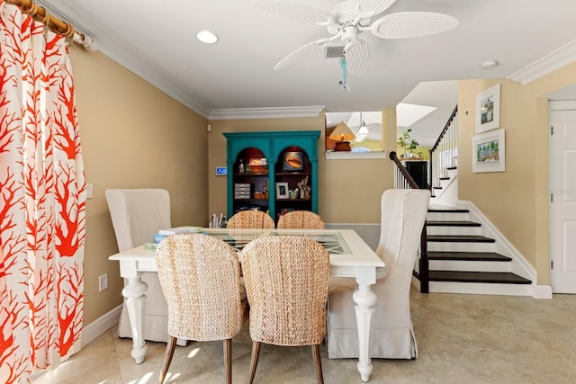 dining room with stairway, baseboards, a ceiling fan, and ornamental molding