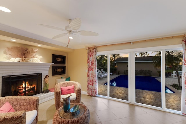 interior space featuring recessed lighting, a ceiling fan, a fireplace, and tile patterned flooring