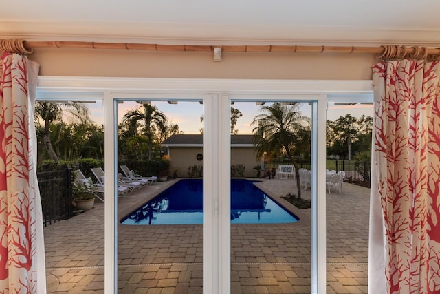 view of pool at dusk