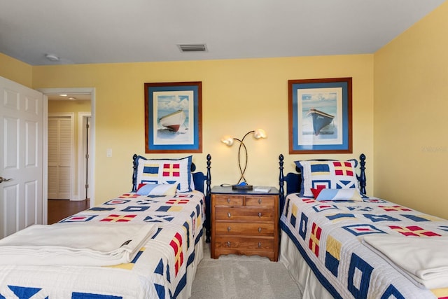 carpeted bedroom featuring visible vents