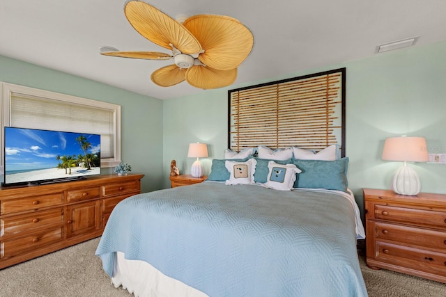 carpeted bedroom with a ceiling fan and visible vents