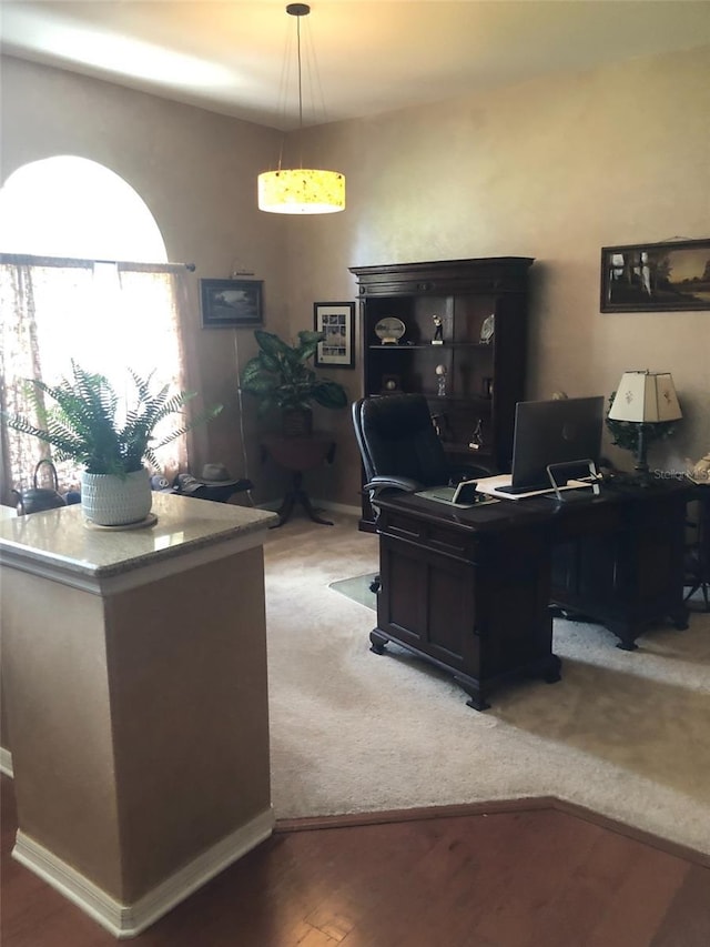 home office with light wood finished floors and baseboards