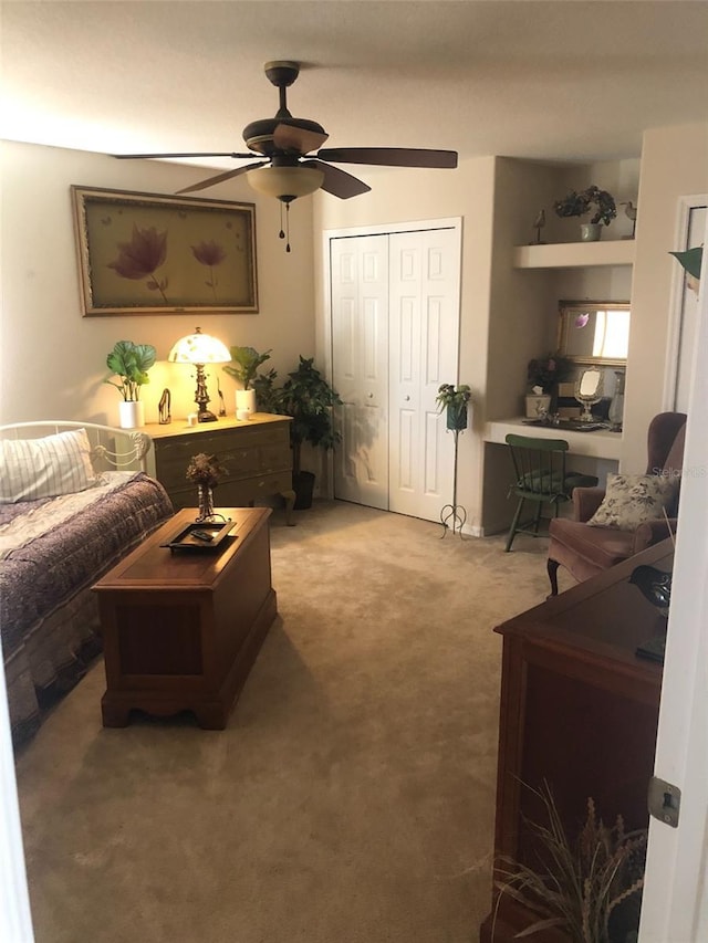 living room featuring carpet and ceiling fan