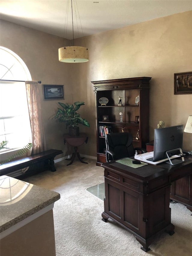 office space featuring light colored carpet and baseboards