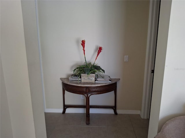 hallway featuring baseboards and light tile patterned floors