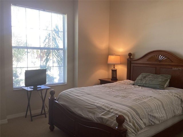 carpeted bedroom with baseboards