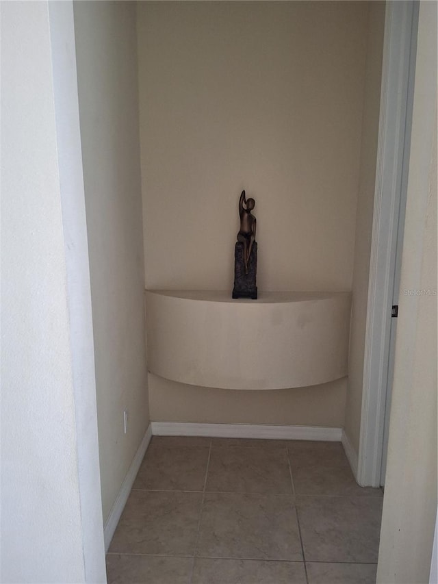 interior space featuring tile patterned flooring and baseboards