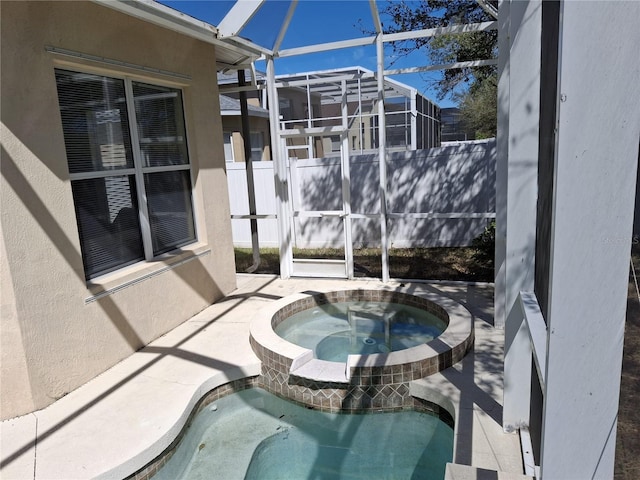 view of patio / terrace with glass enclosure, an outdoor pool, and an in ground hot tub