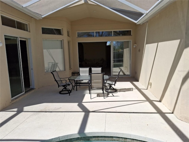 view of patio / terrace featuring a lanai and outdoor dining area