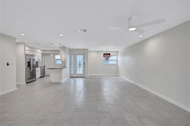 unfurnished living room featuring visible vents, recessed lighting, baseboards, and ceiling fan