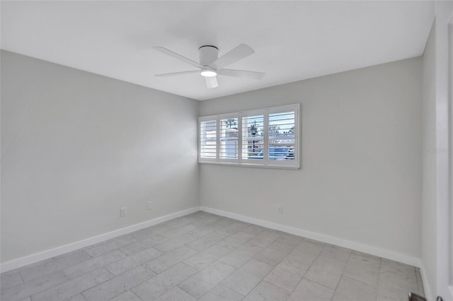 unfurnished room featuring baseboards and ceiling fan