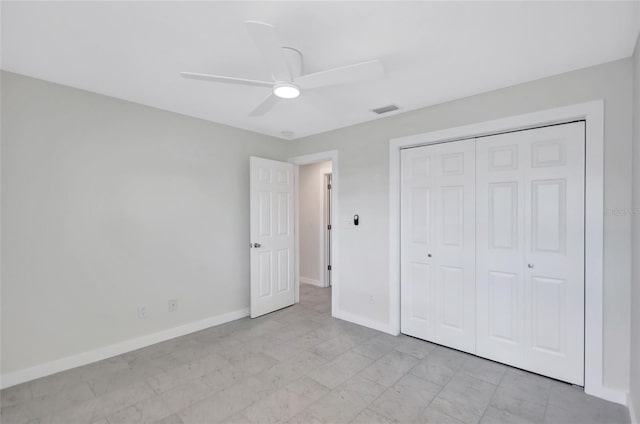 unfurnished bedroom with a ceiling fan, visible vents, baseboards, and a closet