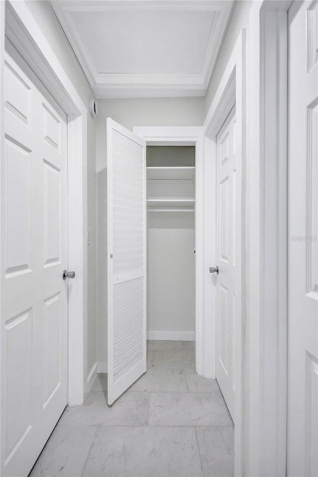 unfurnished bedroom with a closet, marble finish floor, and baseboards