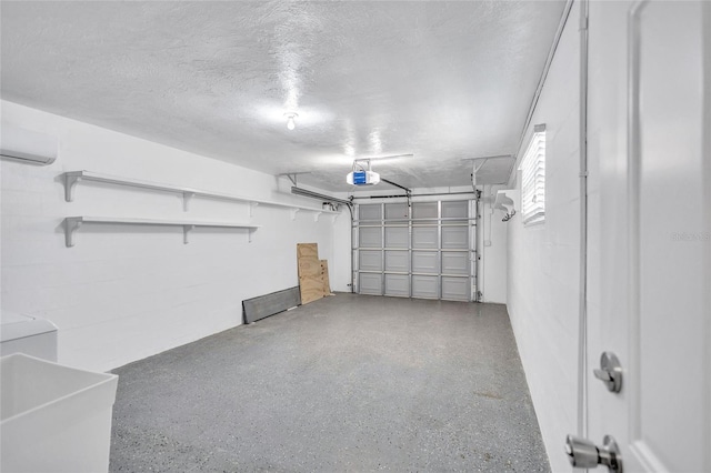 garage with a sink, a garage door opener, and a wall mounted AC