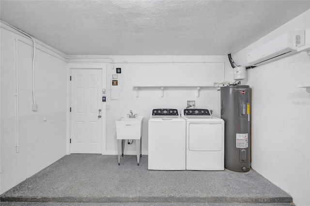 clothes washing area with concrete block wall, water heater, a wall mounted air conditioner, a textured ceiling, and independent washer and dryer