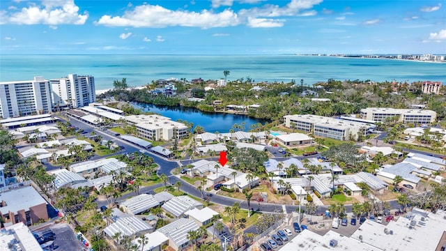 birds eye view of property with a view of city and a water view