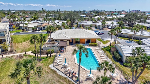 community pool featuring a residential view and fence