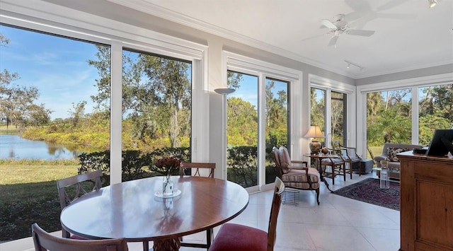 sunroom with a water view, ceiling fan, and track lighting