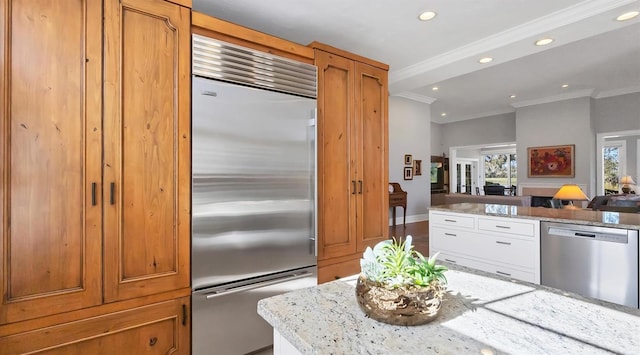 kitchen featuring ornamental molding, light stone counters, open floor plan, stainless steel appliances, and recessed lighting