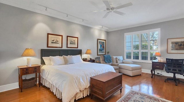 bedroom featuring ornamental molding, ceiling fan, hardwood / wood-style floors, and baseboards