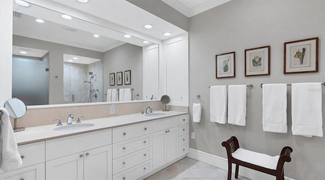 bathroom featuring a shower stall, crown molding, and a sink