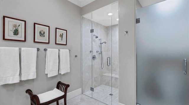 full bath featuring a shower stall and baseboards