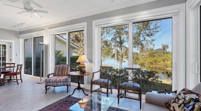 sunroom / solarium with a ceiling fan and rail lighting