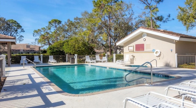 pool featuring a patio area and fence