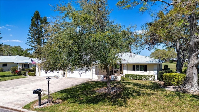 view of front of home with stucco siding, driveway, an attached garage, and a front yard