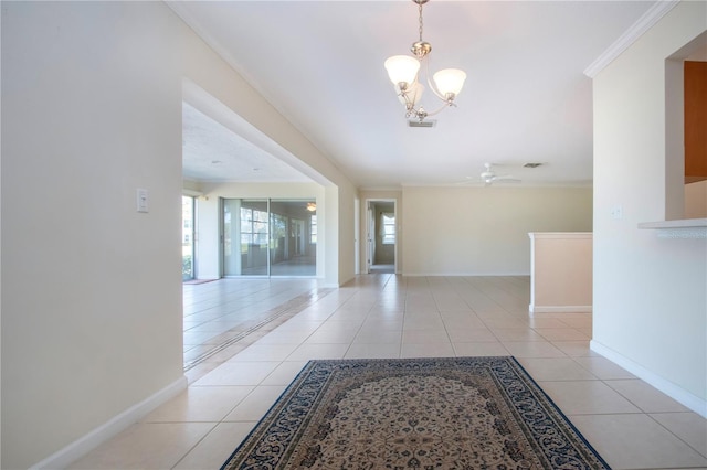 5621 Palm Aire Dr, Sarasota, FL 34243 - corridor with a notable chandelier, light tile patterned floors, crown molding, and baseboards
