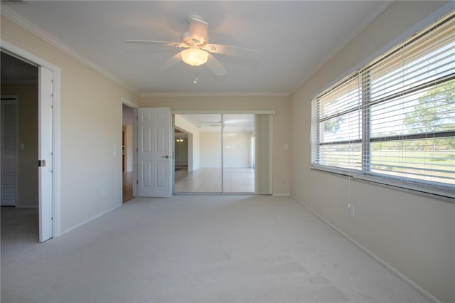 5621 Palm Aire Dr, Sarasota, FL 34243 - unfurnished bedroom with baseboards, carpet floors, a ceiling fan, and crown molding
