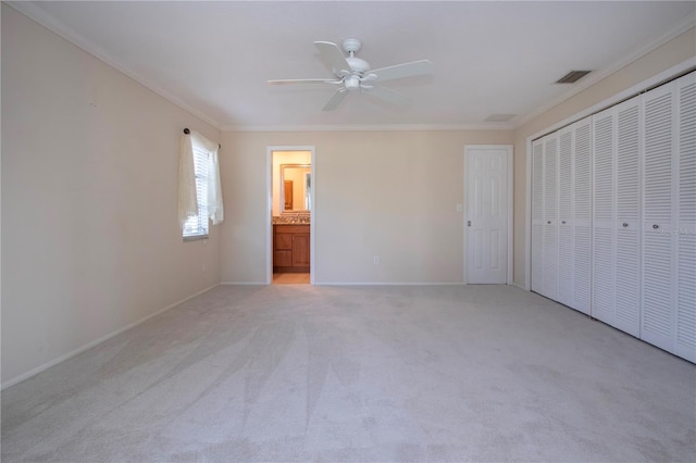 5621 Palm Aire Dr, Sarasota, FL 34243 - unfurnished bedroom with light colored carpet, visible vents, a closet, and ornamental molding