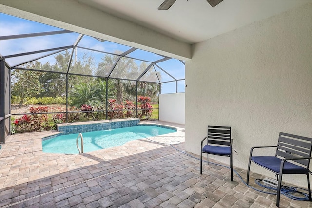 outdoor pool featuring a lanai, ceiling fan, and a patio