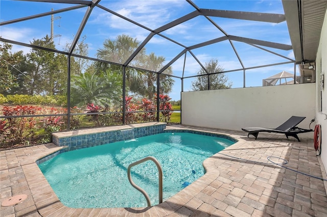 pool featuring glass enclosure and a patio