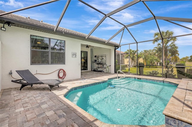 outdoor pool with a patio and glass enclosure