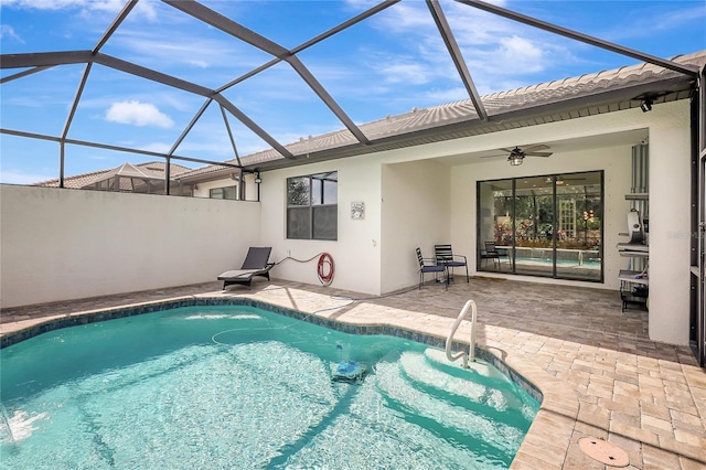 outdoor pool featuring a ceiling fan, a lanai, and a patio area