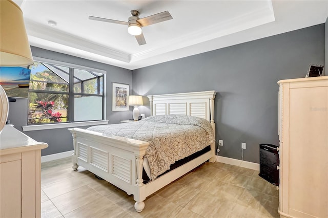 bedroom featuring a raised ceiling, ceiling fan, and baseboards