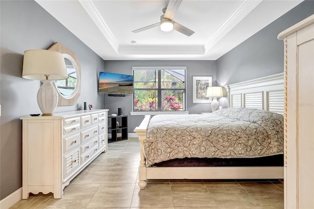 bedroom with baseboards, light tile patterned floors, a raised ceiling, and crown molding