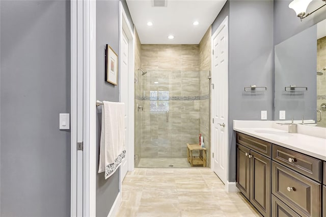 bathroom featuring recessed lighting, visible vents, a shower stall, and vanity