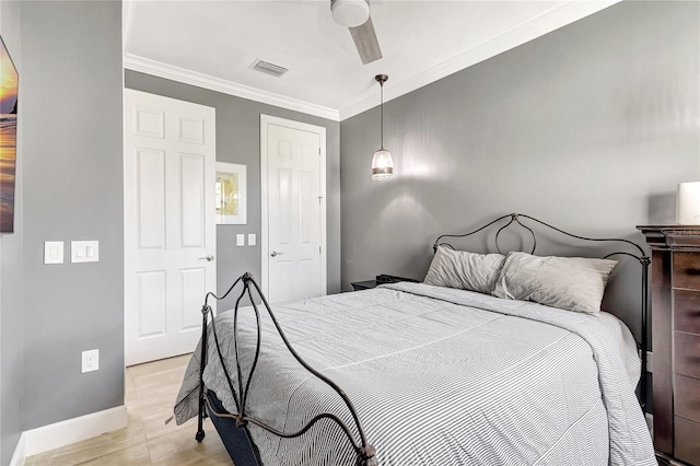 bedroom featuring baseboards, visible vents, ceiling fan, and crown molding