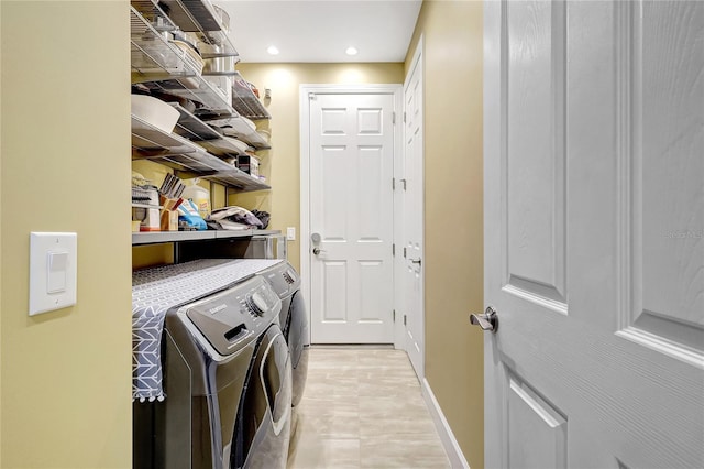 clothes washing area featuring washer and dryer, laundry area, baseboards, and recessed lighting