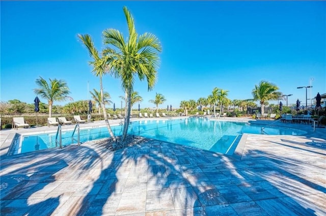 pool featuring a patio and fence