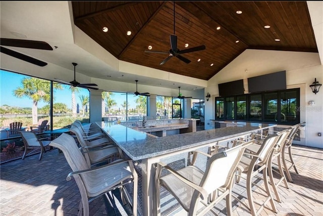 view of patio featuring ceiling fan, a sink, and outdoor wet bar