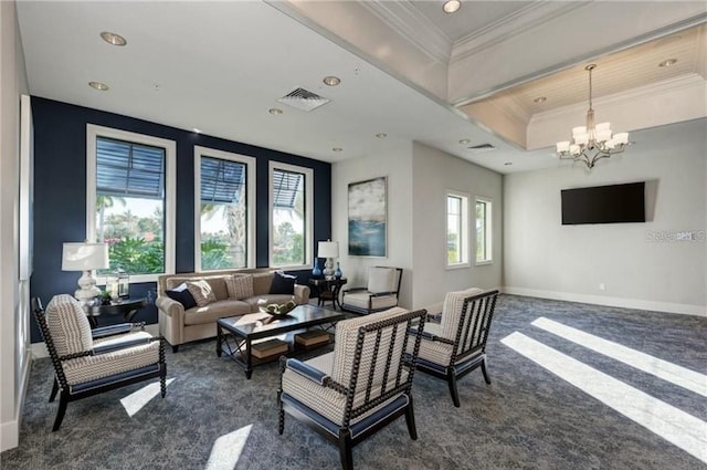 living area with dark colored carpet, visible vents, an inviting chandelier, ornamental molding, and baseboards