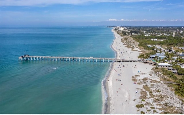 birds eye view of property featuring a water view and a beach view