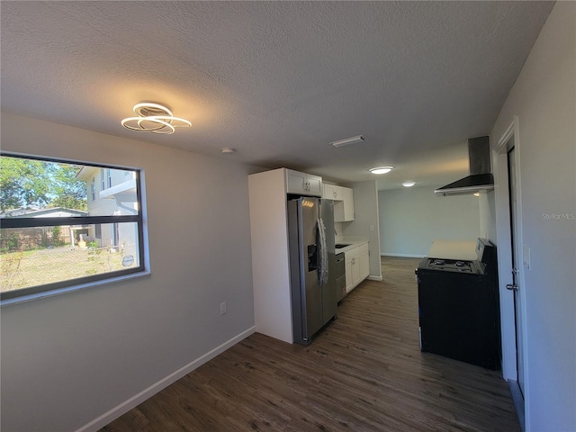 kitchen with wall chimney exhaust hood, stainless steel appliances, dark wood-type flooring, white cabinetry, and baseboards