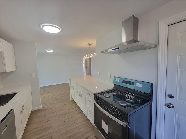 kitchen with wall chimney range hood, white cabinetry, range with electric cooktop, and dishwasher