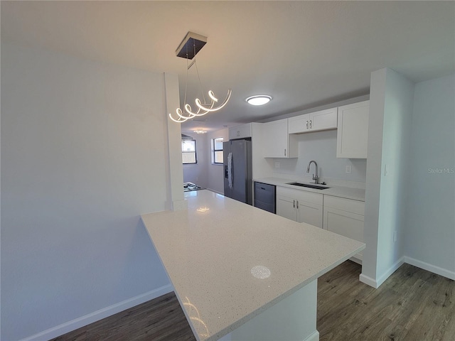 kitchen with dishwasher, stainless steel refrigerator with ice dispenser, a sink, and dark wood finished floors